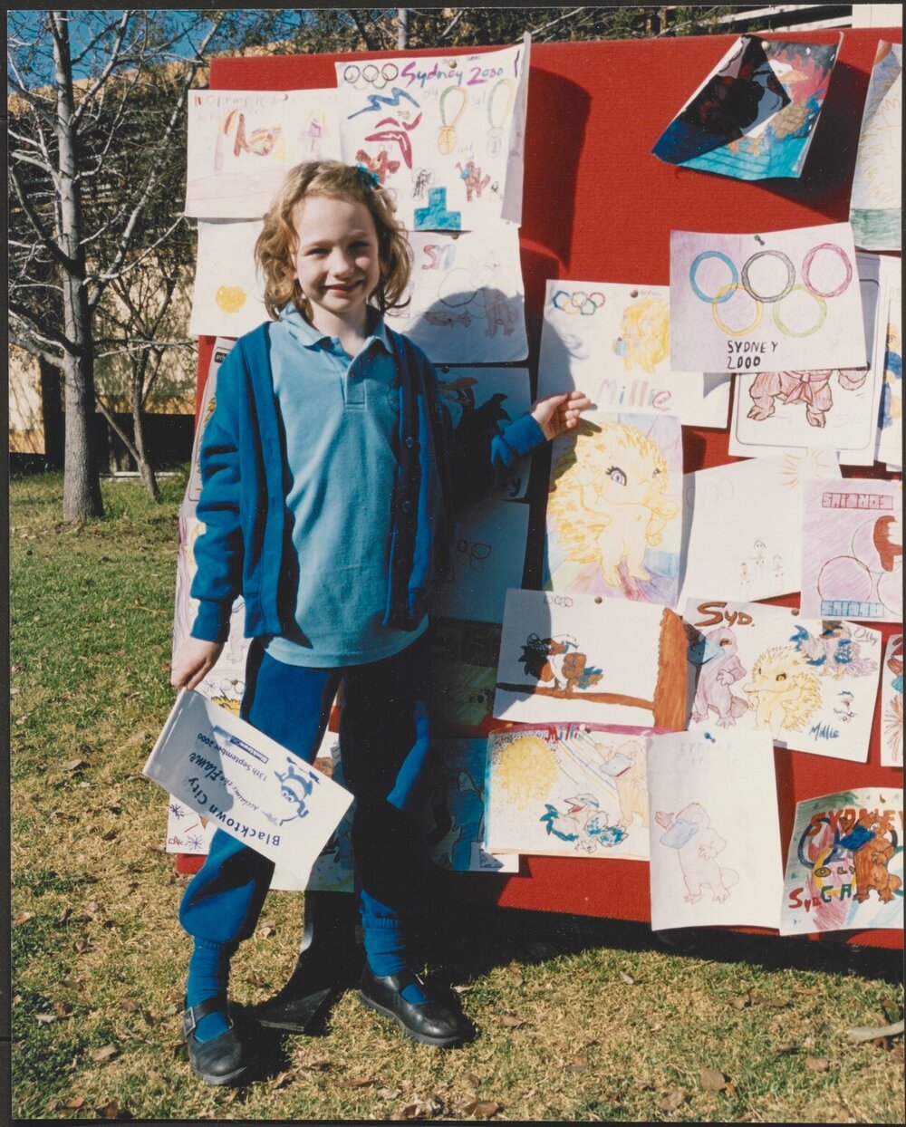 School student with drawings, 2000 Olympics torch relay
