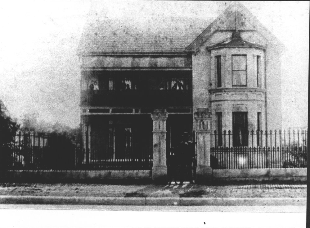 Double storied house with man and boy in gateway