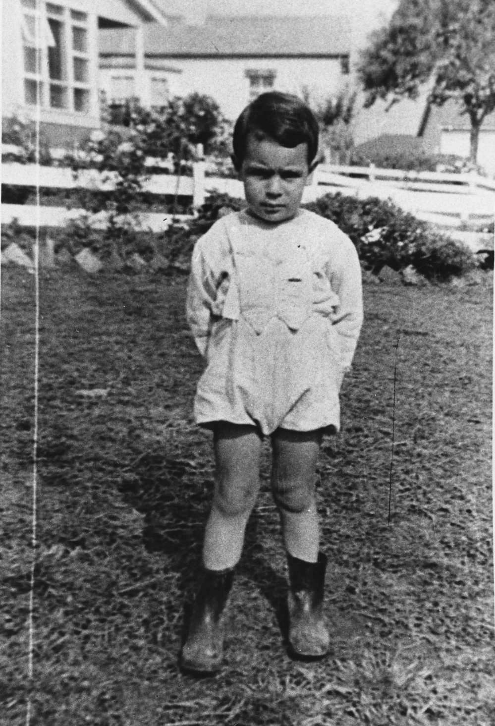 Unknown boy standing in the front garden