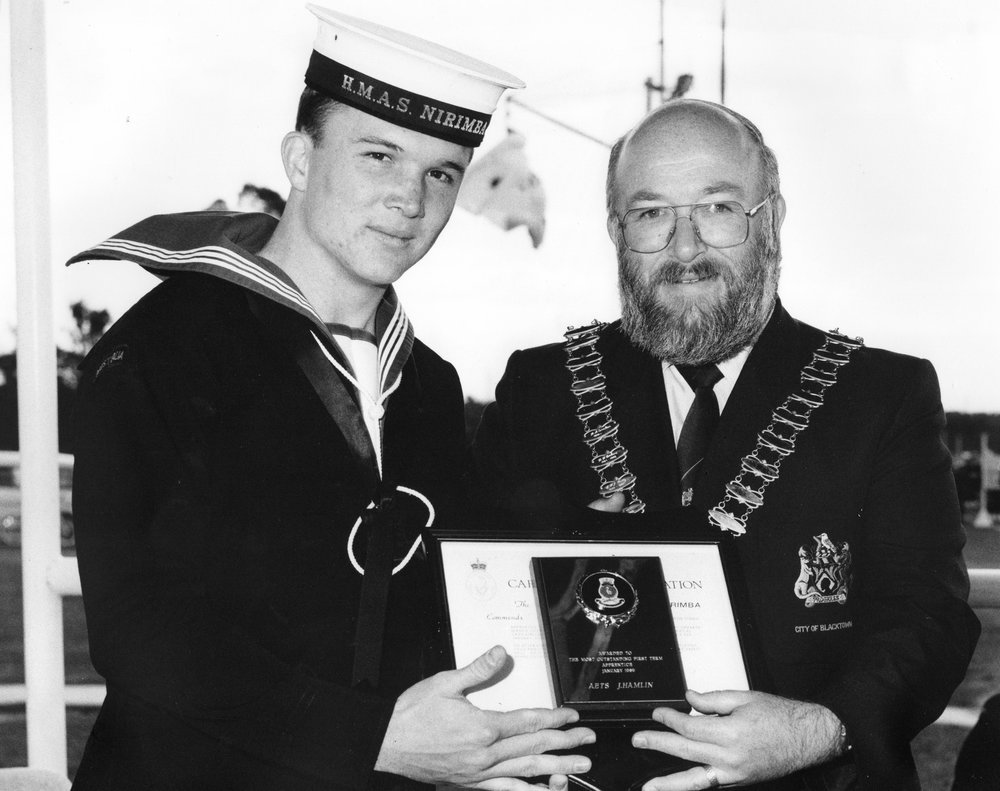 Mayor Robert Sinclair presents award to HMAS Nirimba cadet J. Hamlin
