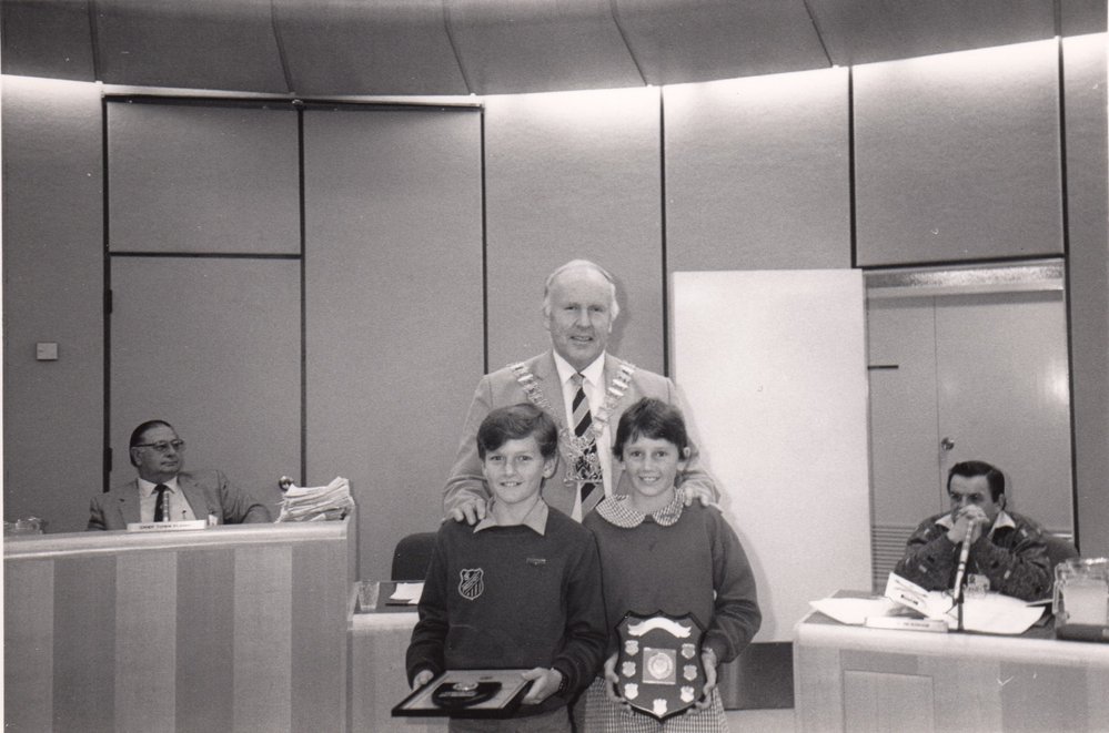 Mayor Leo Kelly with children receiving an award