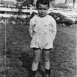 Unknown boy standing in the front garden