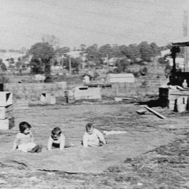Unknown Children sitting on a blanket
