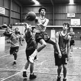 John Paul II Basketball Team in action