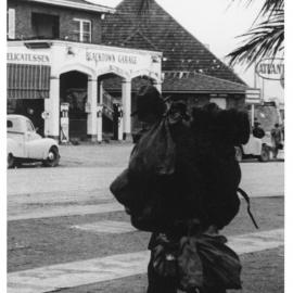 Swagman crossing Main Street, Blacktown, 1958